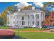 Stunning white brick home with grand columns and circular driveway offers timeless elegance and curb appeal at 1445 Hillside Dr, Grayson, GA 30017