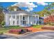 Impressive white brick home featuring stately columns, a circular driveway, and lush landscaping at 1445 Hillside Dr, Grayson, GA 30017
