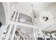 Grand foyer showcasing a staircase, columns, and a striking chandelier at 1445 Hillside Dr, Grayson, GA 30017