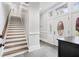 Inviting foyer featuring stairs and decorative glass doors and transom allowing ample natural light at 1445 Hillside Dr, Grayson, GA 30017