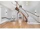 Grand foyer features a curved staircase, hardwood floors, and elegant lighting at 1445 Hillside Dr, Grayson, GA 30017
