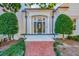 Charming brick home featuring a columned front entrance with brick walkway and manicured landscaping at 1445 Hillside Dr, Grayson, GA 30017