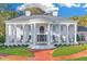 Stately white brick home with grand entrance featuring large columns and manicured landscaping at 1445 Hillside Dr, Grayson, GA 30017