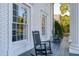 Inviting front porch featuring classic rocking chairs and large windows, perfect for relaxing and enjoying the neighborhood views at 1445 Hillside Dr, Grayson, GA 30017