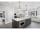Spacious kitchen with an island, white cabinets, stainless steel appliances, and a window at 1445 Hillside Dr, Grayson, GA 30017