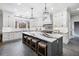 Stylish kitchen featuring an island, white cabinets, stone countertops, and modern lighting at 1445 Hillside Dr, Grayson, GA 30017