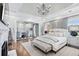 Luxurious main bedroom features tray ceiling, chandelier, and sitting area with lots of natural light at 1445 Hillside Dr, Grayson, GA 30017