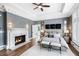 Spacious main bedroom features tray ceiling, fireplace, and large windows, all with hardwood floors at 1445 Hillside Dr, Grayson, GA 30017