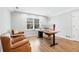 Home office featuring hardwood floors, a large picture window, and a modern desk with two monitors at 1445 Hillside Dr, Grayson, GA 30017
