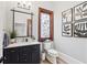Charming powder room with stained glass window, modern vanity, and decorative artwork at 1445 Hillside Dr, Grayson, GA 30017