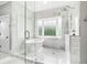 Bright bathroom showcases a glass enclosed shower, bay window, and free standing tub at 1445 Hillside Dr, Grayson, GA 30017