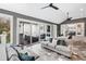 Comfortable sun room featuring dual seating areas, decorative pillows and access to an outdoor patio at 1445 Hillside Dr, Grayson, GA 30017