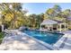 Stunning swimming pool with a waterfall feature, surrounded by lounge chairs and lush landscaping, perfect for relaxing and unwinding at 1445 Hillside Dr, Grayson, GA 30017