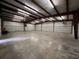 Spacious and industrial warehouse interior featuring high ceilings, ample room for storage, and durable concrete floors at 1445 Hillside Dr, Grayson, GA 30017