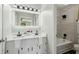 Bright bathroom with a double sink vanity, updated fixtures, and a shower and tub combo at 2284 Briarwood Cir, Conyers, GA 30094