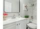 Charming bathroom with a decorative mirror, accent paint, modern fixtures, and a shower-tub combo at 2284 Briarwood Cir, Conyers, GA 30094