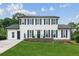 Charming two-story home with a well-manicured lawn and black shutters on the windows at 2284 Briarwood Cir, Conyers, GA 30094