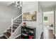 Hallway features a staircase with white railing, hardwood floors, and decorative painting at 2284 Briarwood Cir, Conyers, GA 30094