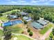 Stunning aerial view of the community clubhouse featuring tennis courts, a pool, and lush greenery at 3770 Clubland Trl, Marietta, GA 30068