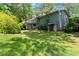 View of the back of the house featuring a deck and well-maintained lawn at 3770 Clubland Trl, Marietta, GA 30068