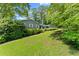 Attractive single-story home surrounded by mature trees and lush landscaping on a well-manicured lawn at 3770 Clubland Trl, Marietta, GA 30068