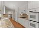 Bright kitchen features white cabinets, stainless appliances, and granite countertops at 3770 Clubland Trl, Marietta, GA 30068