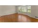 Bright living room featuring hardwood floors and a large bay window overlooking the yard at 3770 Clubland Trl, Marietta, GA 30068