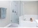 A bathroom featuring a shower-tub combo with white subway tile and a glass enclosure at 4766 Longcourt Se Dr # 23, Atlanta, GA 30339