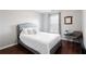 A serene bedroom with a queen bed, chair, and a large window with natural light at 4766 Longcourt Se Dr # 23, Atlanta, GA 30339