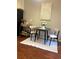 Bright breakfast nook features hardwood floors, a black table with two chairs, and a white rug at 4766 Longcourt Se Dr # 23, Atlanta, GA 30339