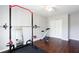 A home exercise room with an exercise bike, weight equipment, and dark hardwood floors at 4766 Longcourt Se Dr # 23, Atlanta, GA 30339