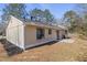 A spacious backyard featuring a patio and large mature trees at 4912 Bayside Ct, Stone Mountain, GA 30088