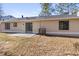 Back exterior of home featuring a sliding glass door and small patio in the backyard at 4912 Bayside Ct, Stone Mountain, GA 30088
