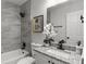 Elegant bathroom with gray tiled shower, granite countertop vanity, and modern fixtures at 4912 Bayside Ct, Stone Mountain, GA 30088