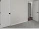 Bedroom featuring neutral carpet and paint plus two closets and a doorway to another room at 4912 Bayside Ct, Stone Mountain, GA 30088