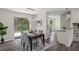 Open concept dining room with backyard view, modern light fixture, and access to the kitchen and living room at 4912 Bayside Ct, Stone Mountain, GA 30088