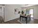 Stylish dining room featuring modern lighting, a view of the backyard, and hardwood floors at 4912 Bayside Ct, Stone Mountain, GA 30088