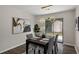 Modern dining area featuring a designer light fixture, backyard access, and hardwood flooring at 4912 Bayside Ct, Stone Mountain, GA 30088