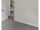 Hallway with carpet, a door leading to another room with a bed, and light-colored walls at 4912 Bayside Ct, Stone Mountain, GA 30088