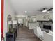 Inviting living room with hardwood floors, a stone fireplace, and views to the dining and kitchen areas at 4912 Bayside Ct, Stone Mountain, GA 30088