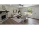Cozy living room featuring a stone fireplace, modern decor, hardwood floors, and large windows at 4912 Bayside Ct, Stone Mountain, GA 30088