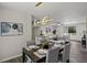 Open-concept living and dining area featuring hardwood floors, modern light fixtures, and neutral color palette at 4912 Bayside Ct, Stone Mountain, GA 30088