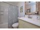Relaxing bathroom features a shower/tub combo with seashell shower curtain, a vanity and decorative mirror at 510 Pineland Sw Rd, Mableton, GA 30126