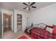 Cozy bedroom features a ceiling fan, closet, and adjacent bathroom for convenient living at 510 Pineland Sw Rd, Mableton, GA 30126