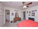 Bedroom features fireplace, red bedspread, ceiling fan, and vanity area at 510 Pineland Sw Rd, Mableton, GA 30126