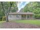 Charming single-story home with a well-maintained lawn and mature trees providing shade and curb appeal at 510 Pineland Sw Rd, Mableton, GA 30126