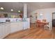 A bright and airy open floor plan showcases the kitchen and dining areas with hardwood floors at 510 Pineland Sw Rd, Mableton, GA 30126