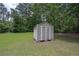 Outdoor storage shed in a spacious, grassy backyard with a privacy fence and mature trees at 510 Pineland Sw Rd, Mableton, GA 30126