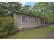 Side view of home featuring clean horizontal siding, surrounded by a lush green yard at 510 Pineland Sw Rd, Mableton, GA 30126