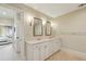 Bright bathroom featuring a double vanity with marble countertops and classic white cabinets at 2700 Paces Ferry Se Rd # 202, Atlanta, GA 30339